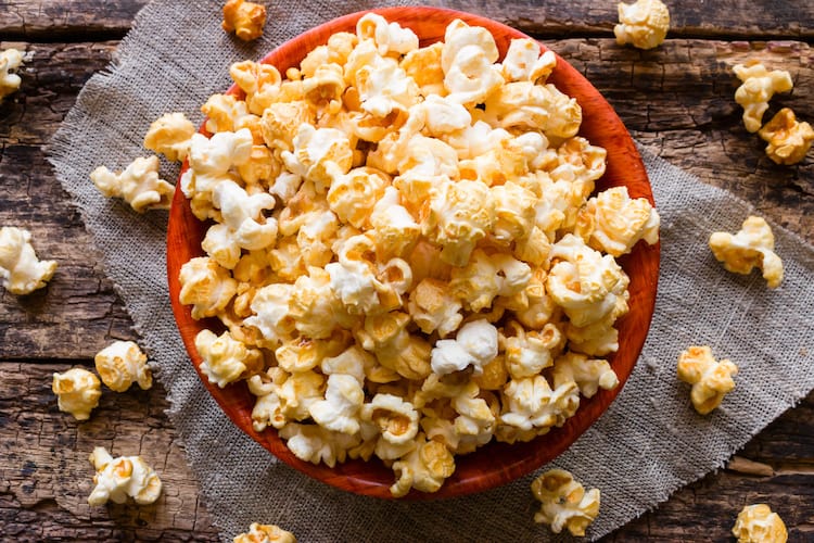 We love this easy homemade caramel popcorn recipe. It only requires a few inexpensive ingredients and it bakes in the oven til it's crispy!