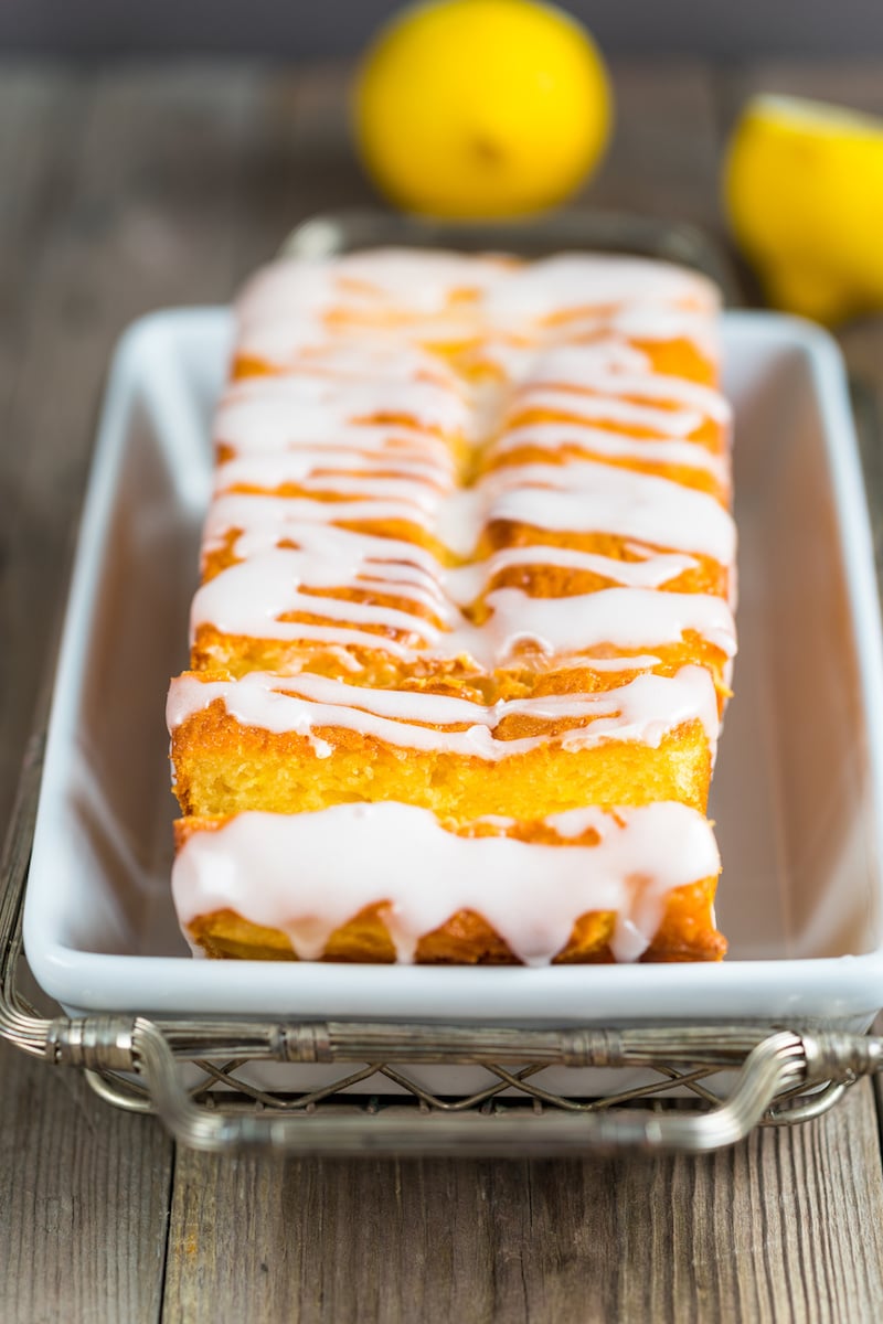 Who doesn't love lemon flavored desserts? This Light Lemon Pound Cake is really easy to make and starts with a boxed cake mix. And it's topped with a lemon glaze. It's an easy bread recipe that's made with a pudding mix. It's just as good as the lemon loaf you find at Starbucks. #lemon #dessert #bread