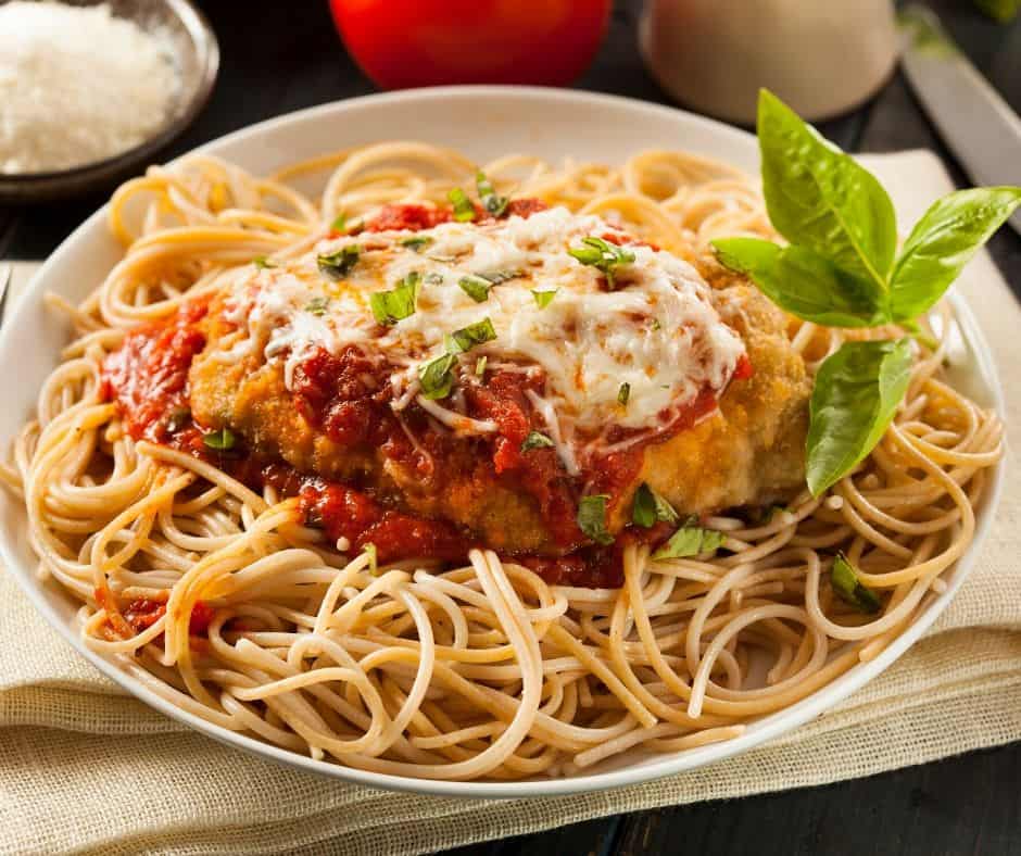 You must try this easy chicken parmesan recipe. It has a deliciously crispy coating, smothered tomato sauce, and melted mozzarella cheese!