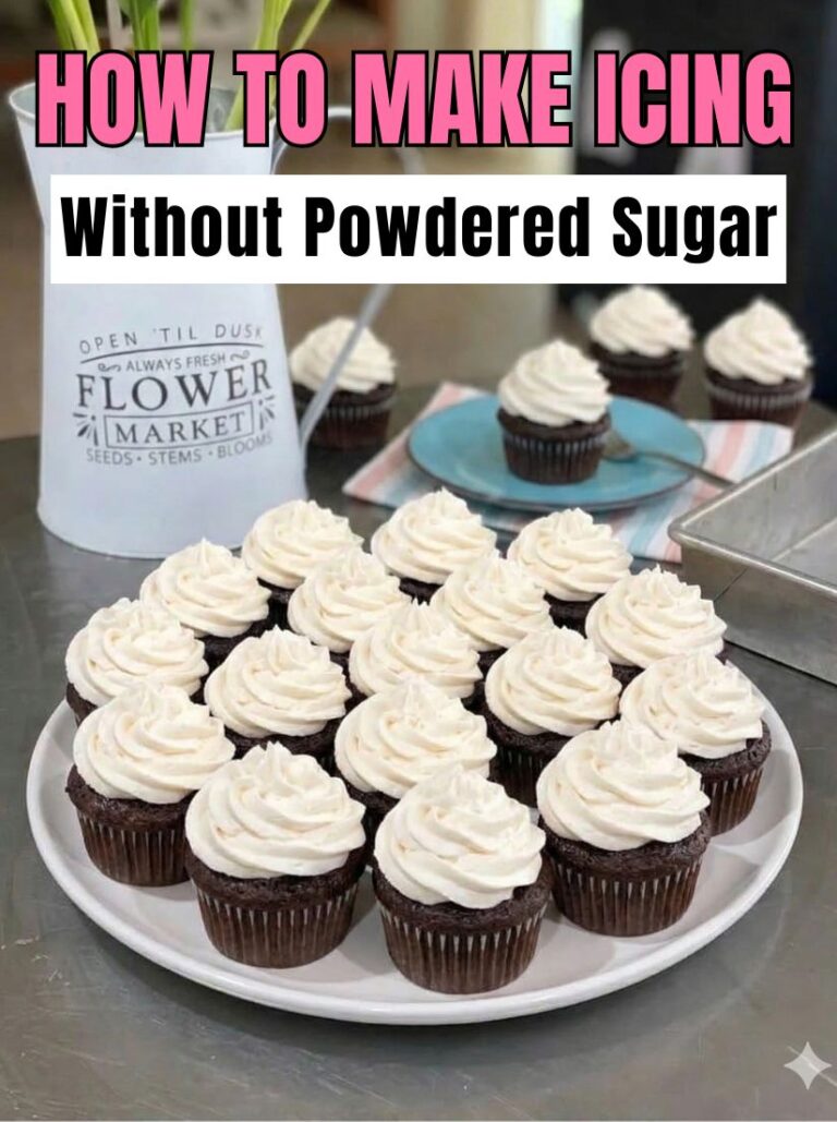 A large platter of two dozen chocolate cupcakes topped with white vanilla frosting swirls, staged in a bright white kitchen.
