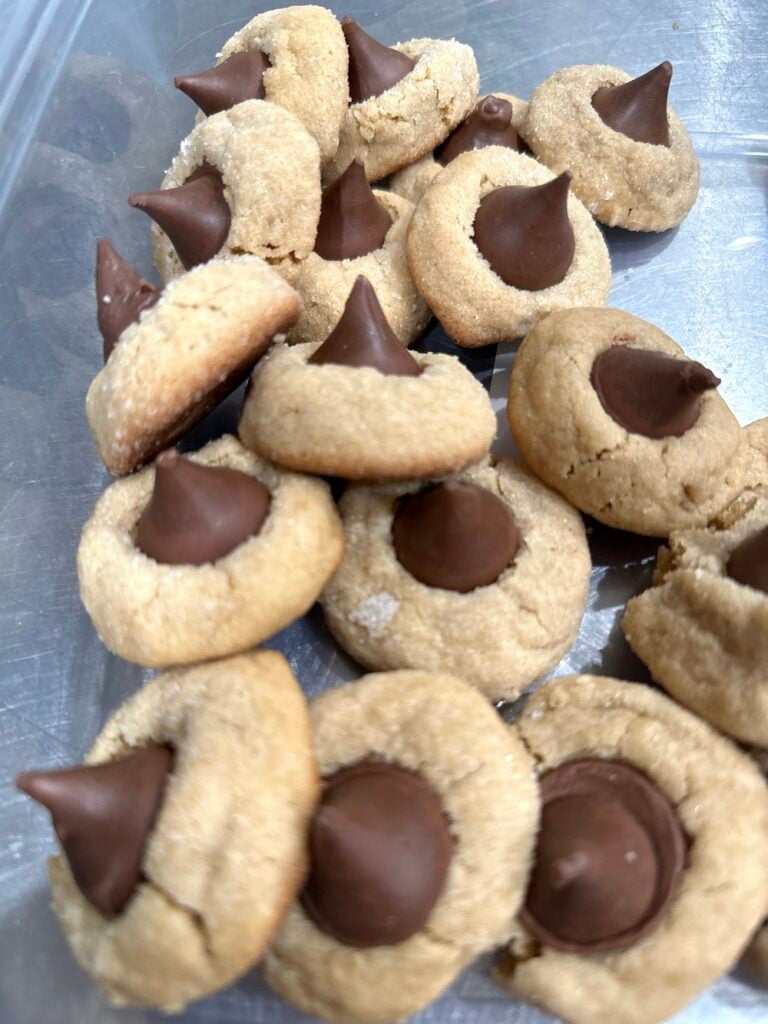 Peanut butter kiss cookies are classic soft peanut butter cookies rolled in sugar and topped with a Hershey chocolate kiss candy in the center.