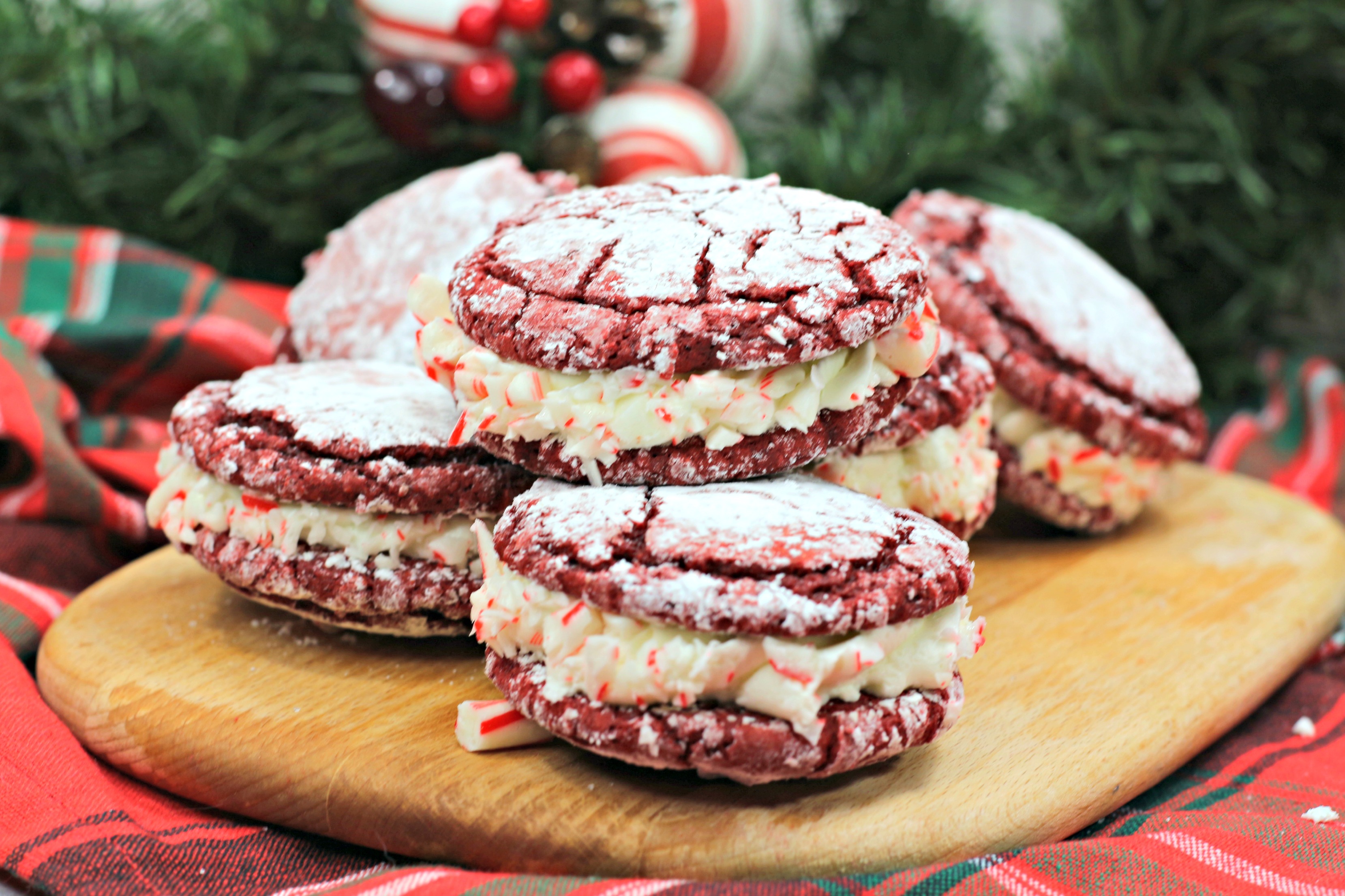 Peppermint Sandwich Cookies are so perfect for Christmas! It's a red velvet cookie filled with peppermint frosting! 