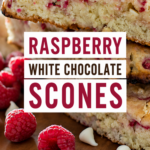 Bakery-style Raspberry White Chocolate Scones with a tender crumb and golden tops on a rustic serving board.