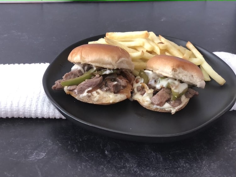 Philly Cheesesteak Sliders are thinly sliced steak and with peppers and onions smothered in Provolone cheese on a soft, toasted slider bun!