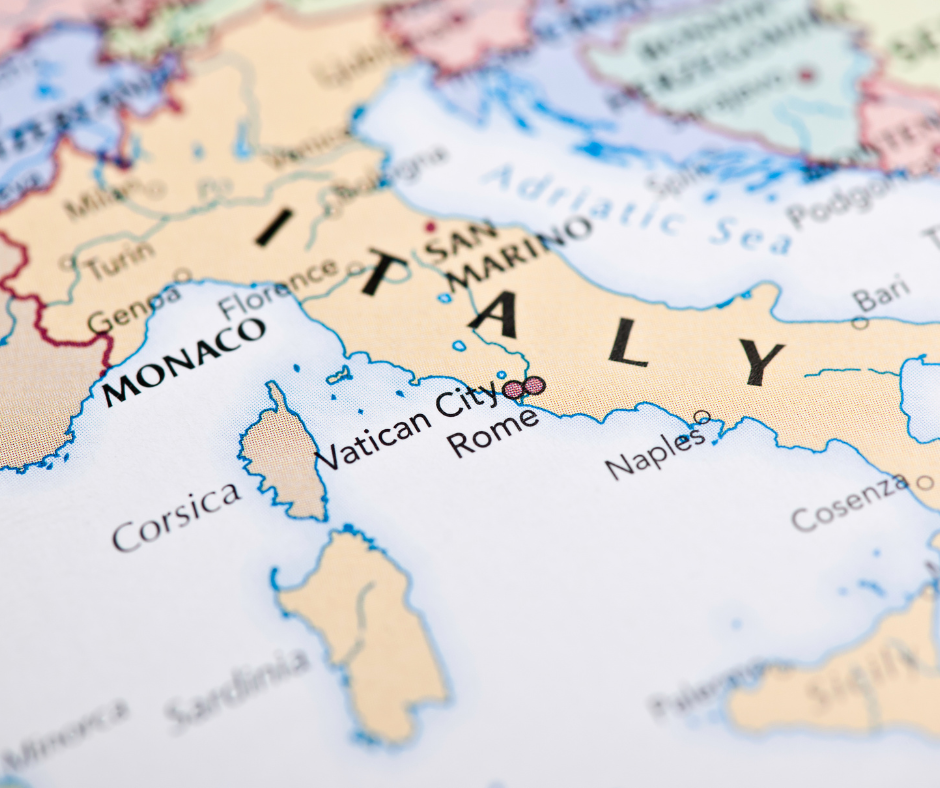 Close-up photograph of an antique-style map focusing on Italy, with cities like Rome, Florence, and Milan clearly visible.