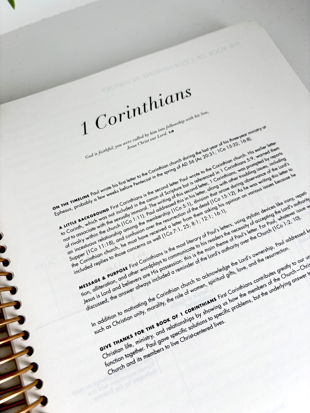 A close-up view of the introduction page for the book of 1 Corinthians in a spiral-bound Bible.