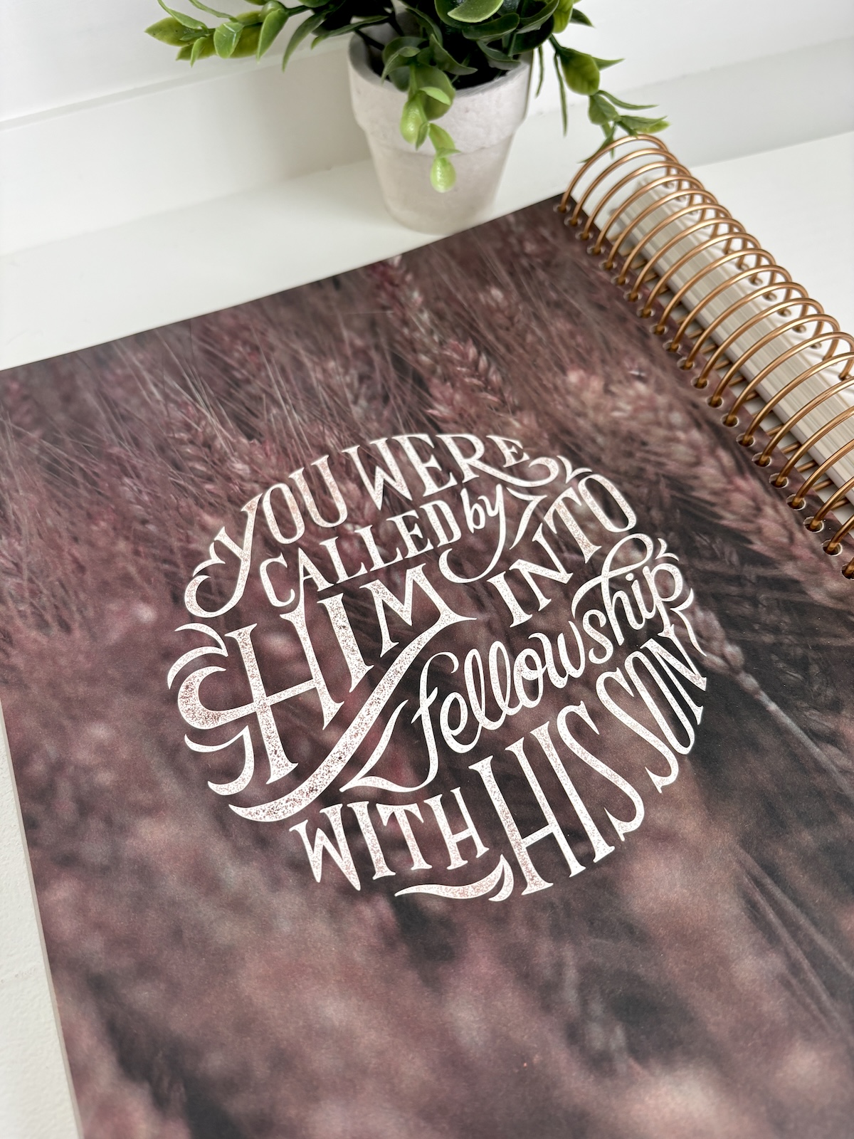 A full-page, beautiful typographical illustration of 1 Corinthians 1:9 over a background of a wheat field.