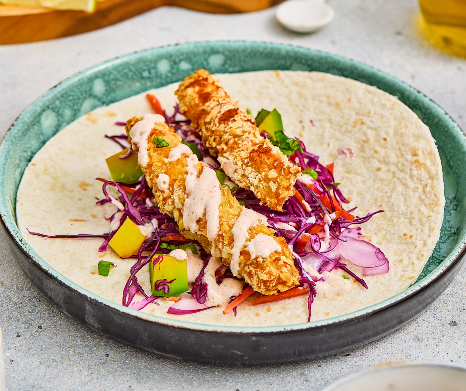 Fish tacos with cabbage slaw served in soft tortillas with a creamy seasoned sauce.