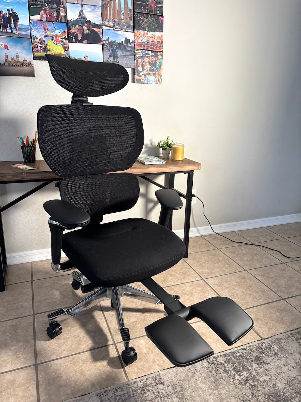 Black ergonomic desk chair with lumbar support and footrest in a home study space, highlighting the benefits of a supportive chair for students. With a footrest
