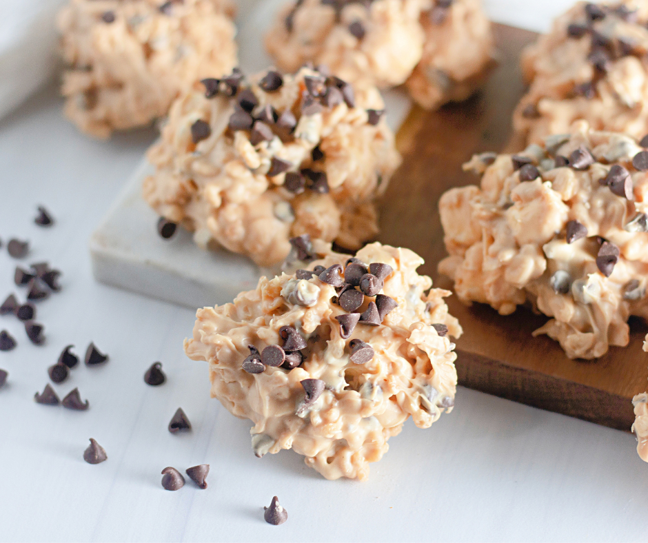 Easy Avalanche Cookies topped with mini chocolate chips on a parchment-lined baking sheet.